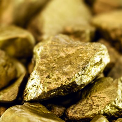 gold stones, rough gold nuggets on black background.